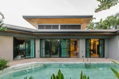a house with a swimming pool in front of it at Ban Bua Lux x MonthStayz Thailand in Rawai Beach