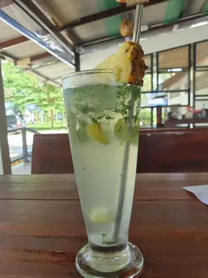 a drink on a table with a banana in it at PAN Beachfront Resort Krabi in Klong Muang Beach
