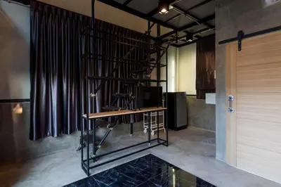 a room with a desk with a television and a curtain at 9BR Neverland Loft Pool Villa in Ban Saiyuan (1)