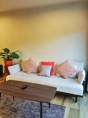 a living room with a couch with pillows on it at Hill Myna Condo by Bcare - Two Bedrooms in Ban Thalat Choeng Thale