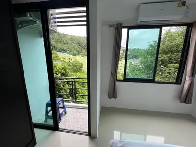 a room with a view of a balcony with a window at Patong Easy Life 6 in Patong Beach