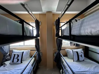 two bunk beds in a room with two beds at Bell Lifestyle Hostel Phuket in Nai Yang Beach