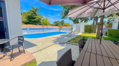 a patio with a table and an umbrella at The Memories Hill Phuket in Thalang