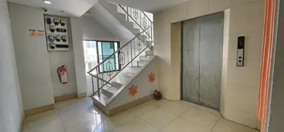 a hallway with a staircase and a door in a building at Royal Sweet Hotel in Patong Beach