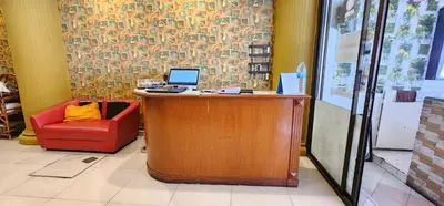 a office with a desk with a laptop and a red chair at Royal Sweet Hotel in Patong Beach