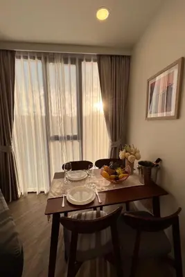a dining room table with a bowl of fruit on it at 1 Bedroom Sky Park corner in Bang Tao Beach