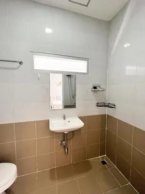 a bathroom with a sink and a toilet at Cinderella Residence in Patong Beach