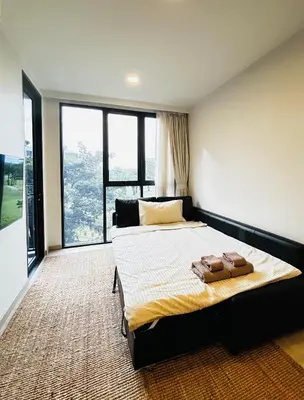 a bedroom with a large bed and a large window at 1 Bdr Sky Park Golf view in Bang Tao Beach