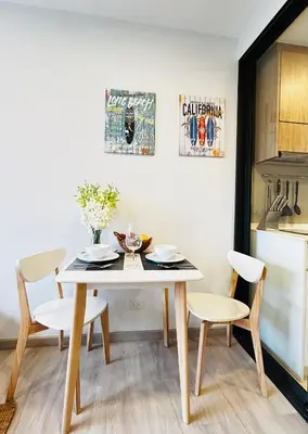 a dining room with a table and two chairs at 1 Bdr Sky Park Golf view in Bang Tao Beach