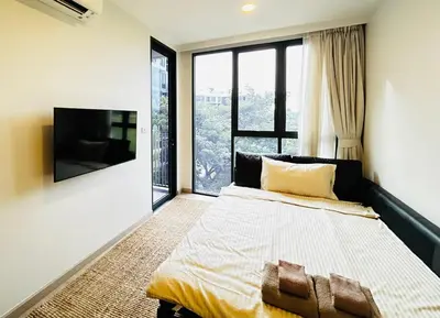 a bedroom with a bed and a large window at 1 Bdr Sky Park Golf view in Bang Tao Beach