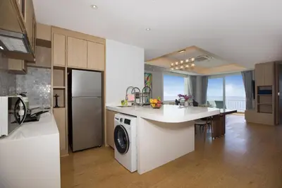 a kitchen with a washer and dryer on a counter at Chic Design & Full Seaview 2BR Karon Condo 16C, near Beach in Karon Beach