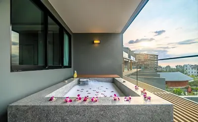 a group of pink birds sitting in a bath tub at Deluxe apartment with sea view and jacuzzi in Surin Beach