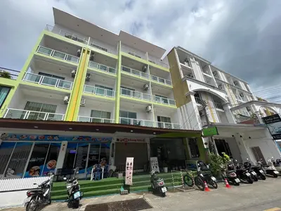 a group of motorcycles parked outside of a building at T & C Hotel Patong Beach in Patong Beach