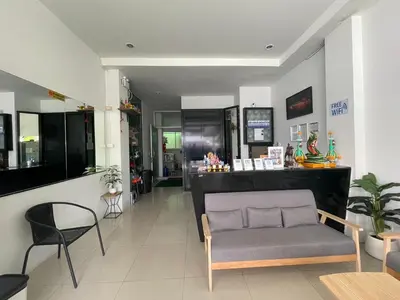 a waiting room with a chair and a counter at T & C Hotel Patong Beach in Patong Beach