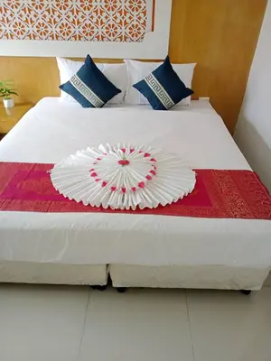 a bed with a paper plate on top of it at T & C Hotel Patong Beach in Patong Beach