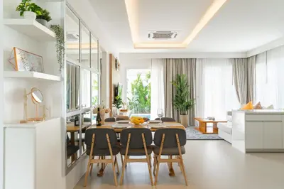a dining room with a table and chairs at Kamala Garden View Villa 3 Bdr in Kamala Beach
