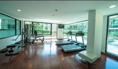 a gym with treadmills and exercise equipment in a building at Panwa Beach Side Beachfront in Panwa Beach