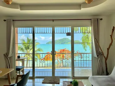 a living room with a view of the ocean at Secret Place in Panwa Beach