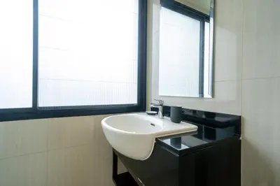 a bathroom with a white sink and a mirror at 3BDR Townhouse in Laguna Park in Bang Tao Beach