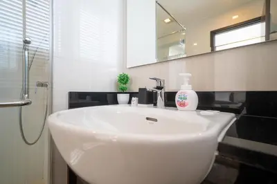 a bathroom with a white sink and a mirror at 3BDR Townhouse in Laguna Park in Bang Tao Beach