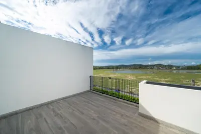 a balcony with white walls and a view of a field at 3BDR Townhouse in Laguna Park in Bang Tao Beach