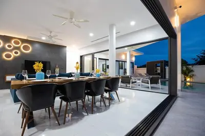 a dining room with a long table and chairs at Villa Brianna Luxuria 4 - Rawai in Rawai Beach