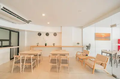 a restaurant with tables and chairs in a room at Patong Diamond Hotel in Patong Beach
