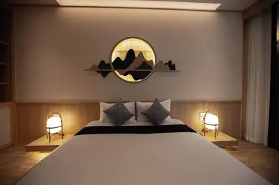 a bedroom with a large bed and a mirror at The Arch Phuket Hotel in Ban Ket Ho