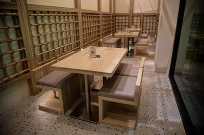 a row of tables and benches in a library at The Arch Phuket Hotel in Ban Ket Ho