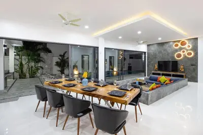 a dining room with a table and a couch at Villa Brianna Luxuria 2 - Rawai in Phuket Town