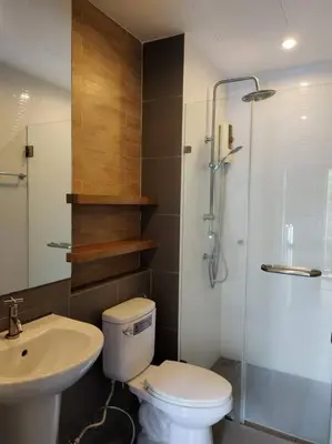a bathroom with a toilet and a shower and a sink at Hill Myna Condotel by Bcare - One Bedroom in Ban Thalat Choeng Thale