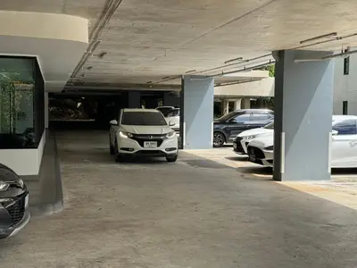 a parking lot with cars parked in a parking garage at Bliss Patong - 2Br Sea View Condo - Roof Top Pool in Patong Beach