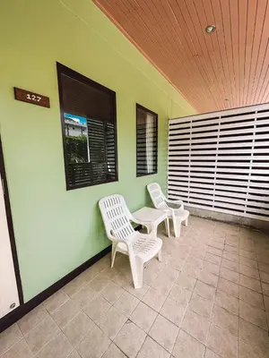 a room with two chairs and a table and two windows at Favorite Place in Kata Beach