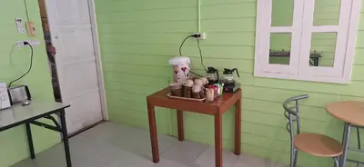 a table in a room with a green wall at Favorite Place in Kata Beach