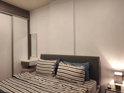 a bedroom with a bed with two pillows on it at 5 Floor - The Base Downtown Condominium next to Central Shopping Mall in Phuket Town
