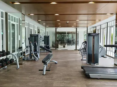 a gym with several treadmills and cardio machines at 5 Floor - The Base Downtown Condominium next to Central Shopping Mall in Phuket Town