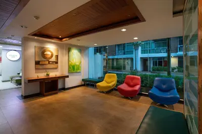a waiting room with four chairs and a desk at iCheck inn Residences Patong in Patong Beach