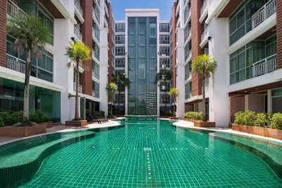 a swimming pool in the middle of a building at iCheck inn Residences Patong in Patong Beach