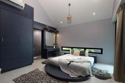 a bedroom with a large bed and a black cabinet at 3bdr Granary Pool Villa Bangtao Beach by CapitalPro GRN-A4 in Phuket Town