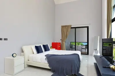 a white bedroom with a bed and a balcony at 3bdr Granary Pool Villa Bangtao Beach by CapitalPro GRN-A4 in Phuket Town