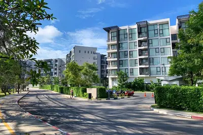 an empty street in a city with tall buildings at Cassia 1 BR Sea View apt by NLA in Bang Tao Beach
