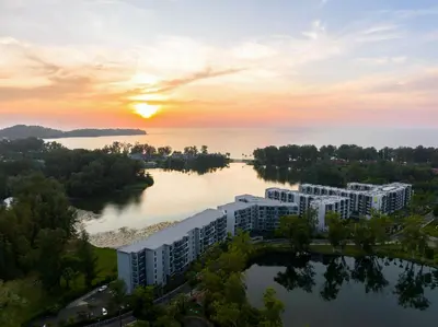 an aerial view of a building on a river at sunset at Cassia 2 BR Sea View&Terrace apt by NLA in Bang Tao Beach
