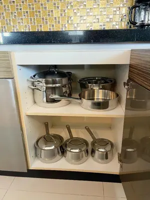 a bunch of pots and pans on a shelf in a kitchen at The Regent Bangtao Apartments gorgeous view of the jungle in Bang Tao Beach