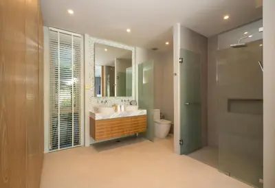 a bathroom with a sink and a toilet and a mirror at 3-Bedroom Pool Villa in Trichada Bangtao in Bang Tao Beach
