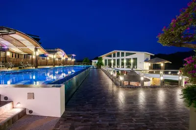 a view of the pool of a hotel at night at Chalong Miracle Lakeview in Chalong