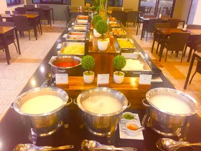 a long buffet of food in a restaurant at Chalong Miracle Lakeview in Chalong