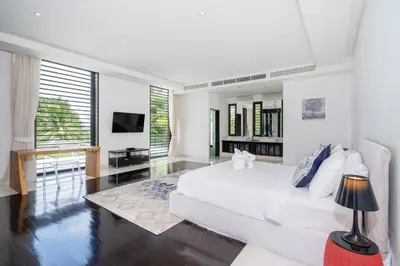 a white bedroom with a white bed and a television at Full Seaview 5BR Villa Serenity, Elite Living at Cape Yamu in Ban Bang La