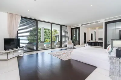 a white bedroom with a large bed and a tv at Full Seaview 5BR Villa Serenity, Elite Living at Cape Yamu in Ban Bang La