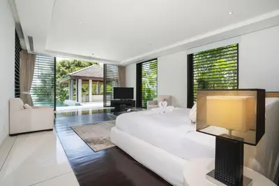 a white bedroom with a large bed and a television at Full Seaview 5BR Villa Serenity, Elite Living at Cape Yamu in Ban Bang La
