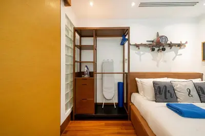a bedroom with a bed and a bathroom with a shower at Naithon beachfront apartment-pool gym restaurant in Nai Thon Beach